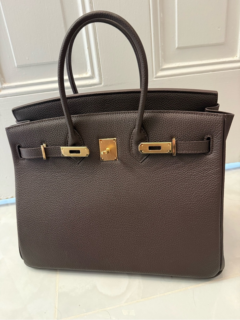 Elegant Brown Leather Satchel with Gold Hardware, size of Birkin 35